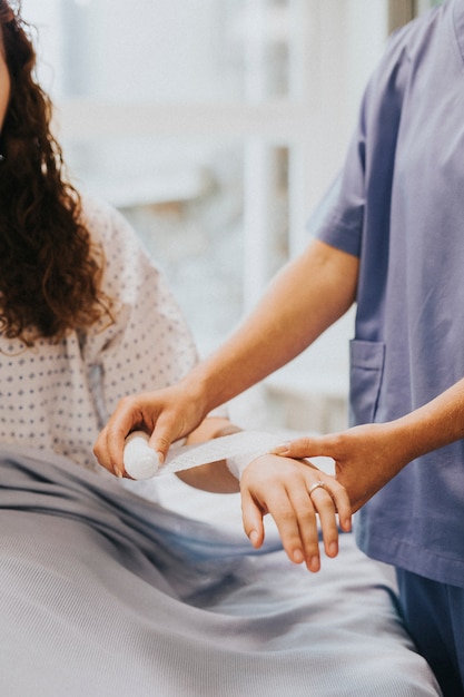 Free Photo nurse bandaging the patients arm