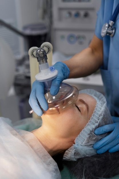 Nurse putting oxygen mask to patient