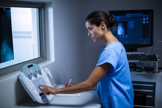 Nurse taking notes in x-ray room