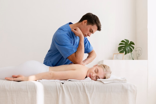 Nurse with patient in osteopathy session