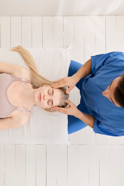 Nurse with patient in osteopathy session