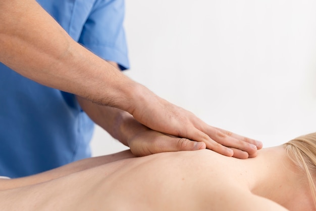 Nurse with patient in osteopathy session