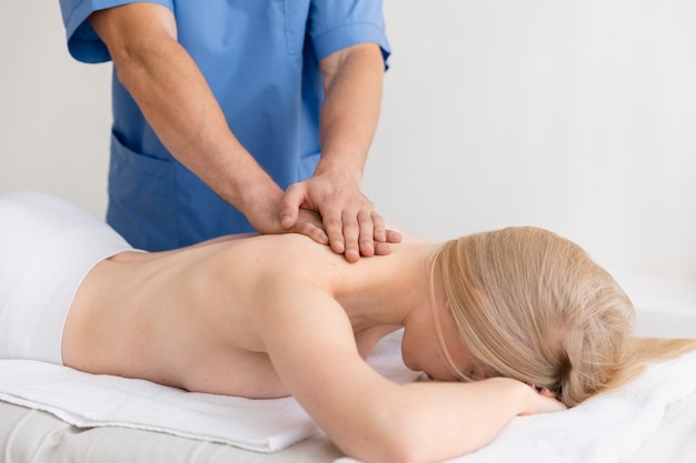 Nurse with patient in osteopathy session