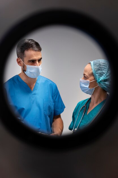 Nurses discussing at work side view