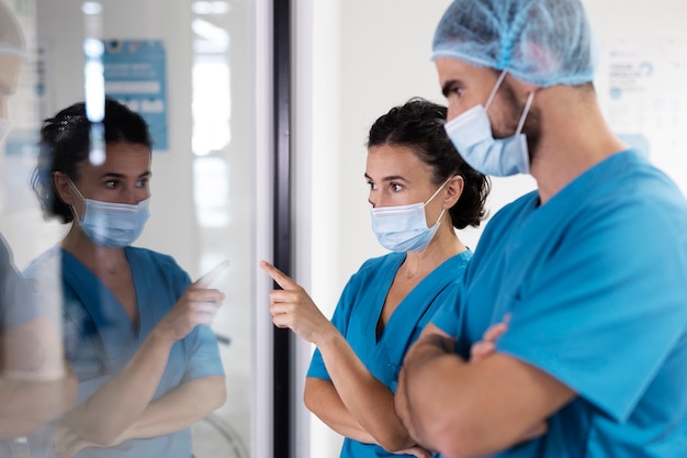 Free photo nurses wearing face masks side view