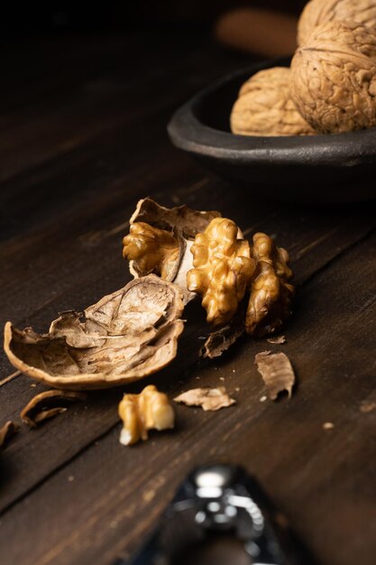 Nutcracker and cracked walnuts on a wooden table