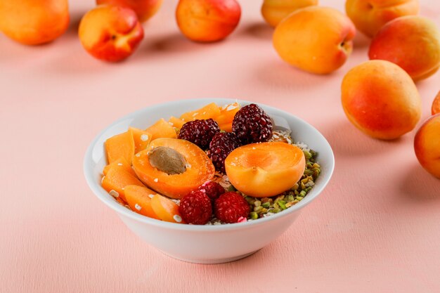 Oat flakes with pistachio, apricot, berries in a bowl