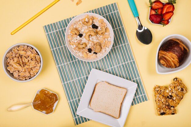 Oatmeal in bowl with toast and berries on table