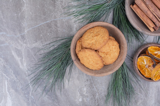 Free Photo oatmeal cookies on a wooden cup with cinnamon and orange slices