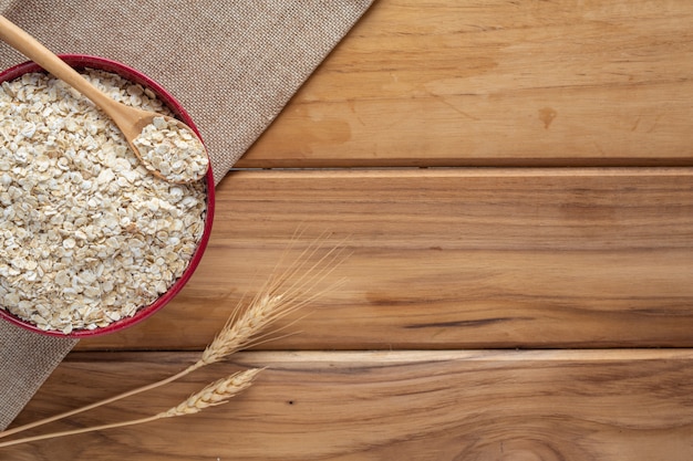 Oatmeal is placed on a brown wood .