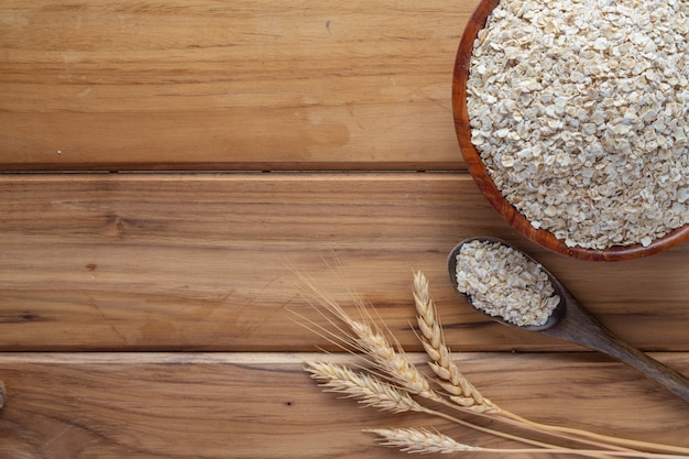 Oatmeal is placed on a brown wood .