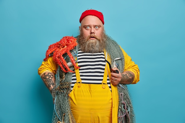 Free Photo obese bearded male sailor wiith fishing net