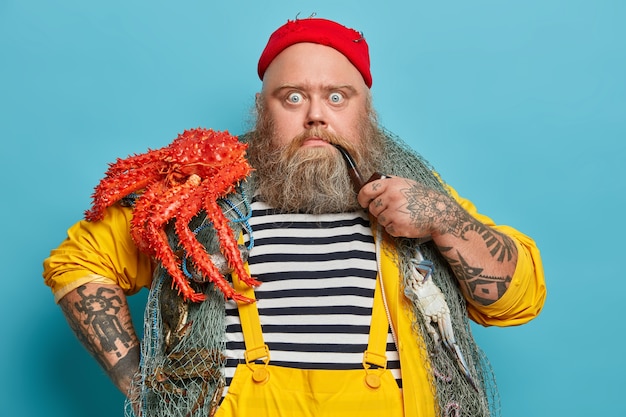 Free Photo obese bearded male sailor wiith fishing net