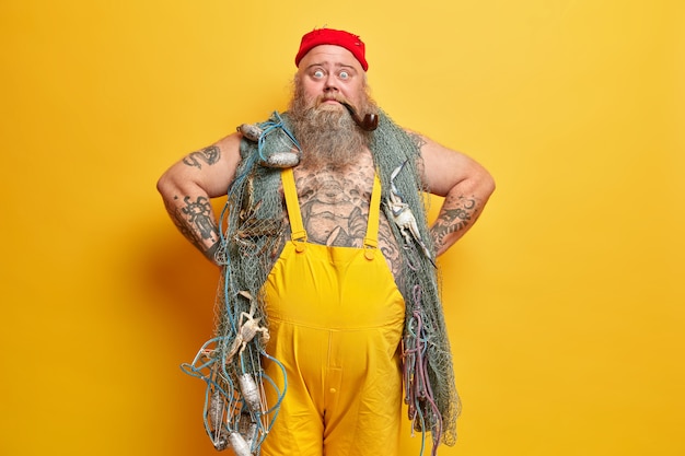 Free Photo obese bearded male sailor wiith fishing net