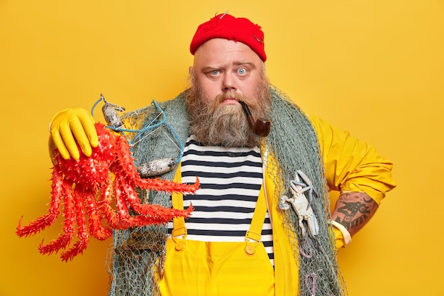 Free photo obese bearded male sailor wiith fishing net