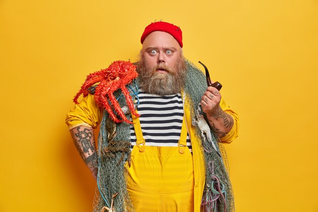 Free Photo obese bearded male sailor wiith fishing net