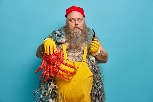 Free Photo obese bearded male sailor wiith fishing net