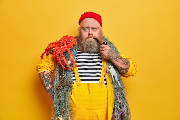 Free Photo obese bearded male sailor wiith fishing net