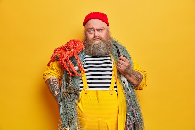 Free Photo obese bearded male sailor wiith fishing net