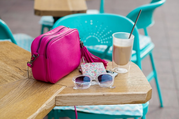 Free Photo objects arranged on table in city cafe in street