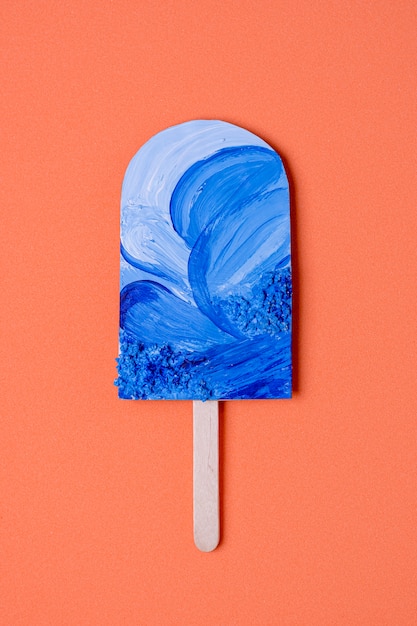 Free photo ocean blue painted ice cream on stick top view