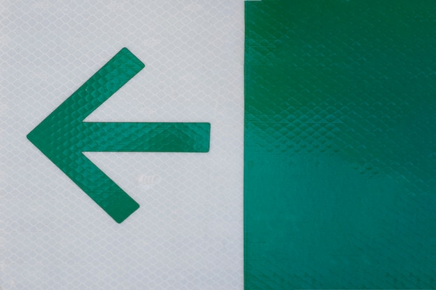 Free photo office arrow on grey and green background