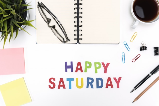 Free photo office desk table with happy saturday word