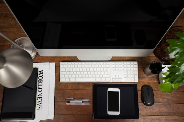 Office desk with computer, digital tablet and mobile phone