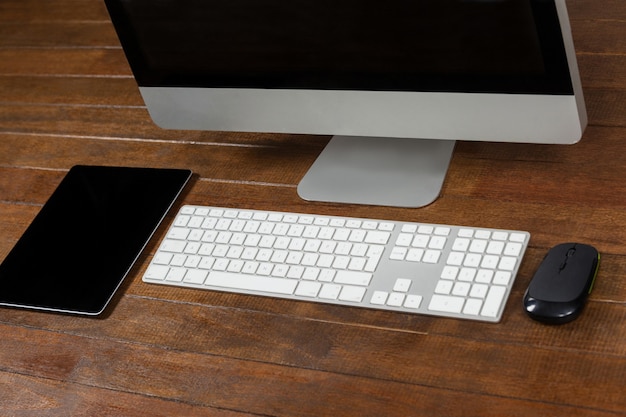 Office desk with computer and digital tablet