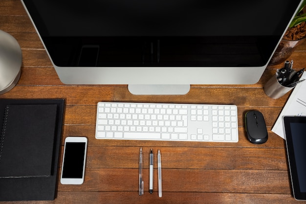 Office desk with computer and mobile phone