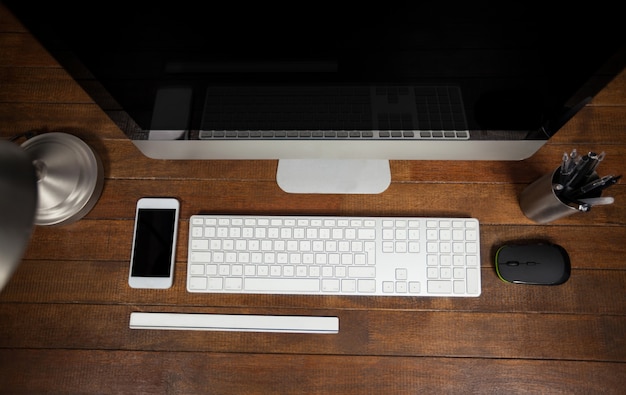 Office desk with computer and mobile phone