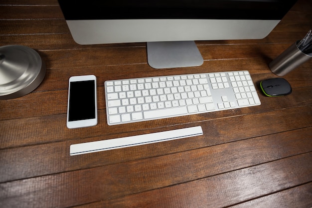 Office desk with computer and mobile phone