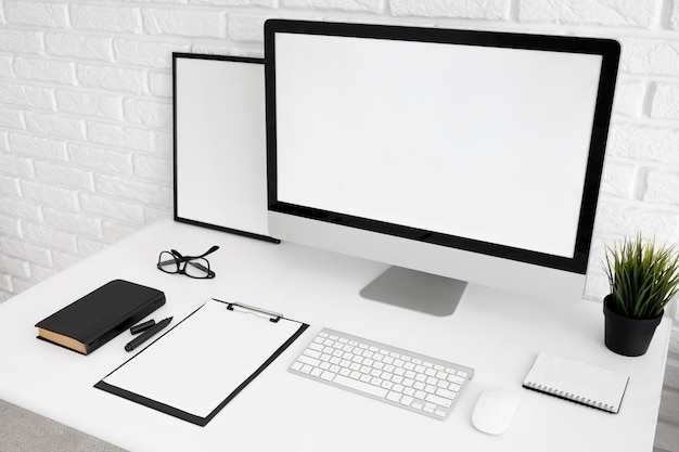 Free Photo office desk with computer screen and clipboard