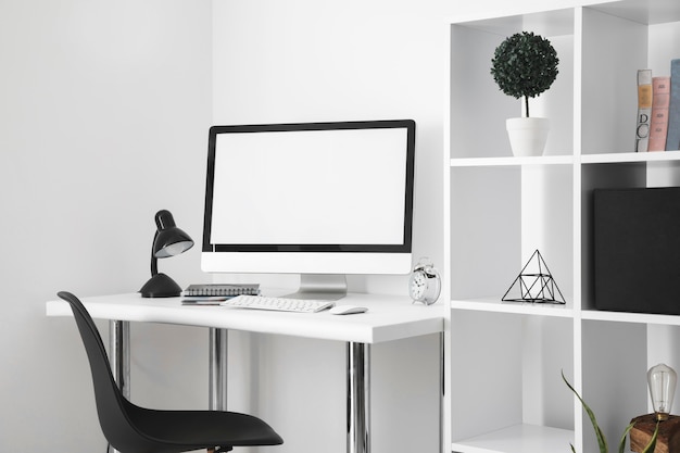 Office desk with computer screen and desk chair