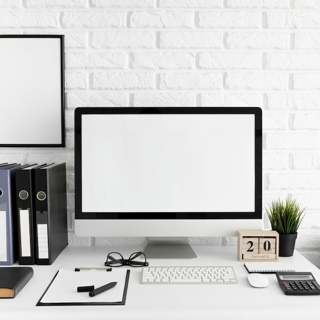 Free photo office desk with computer screen and keyboard