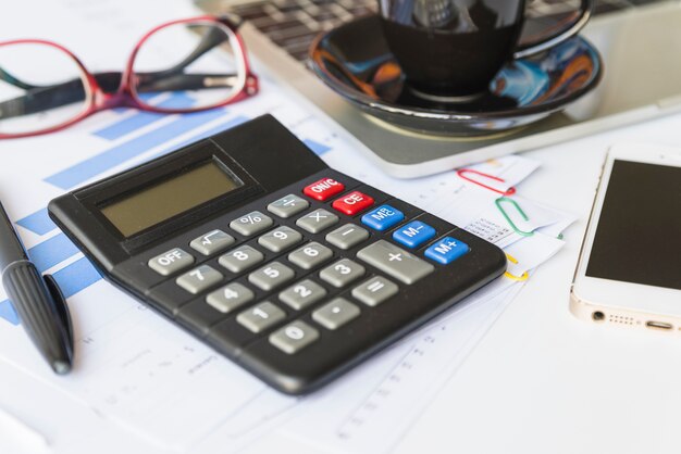 Office desk with tools and coffee cup