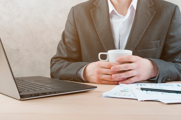 Office desktop with laptop and a business man