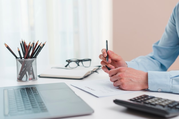 Office desktop with laptop and a calculator