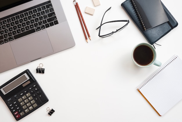 Office desktop with laptop and a coffee cup