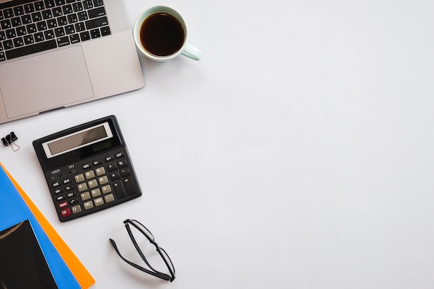 Office desktop with laptop and a coffee cup