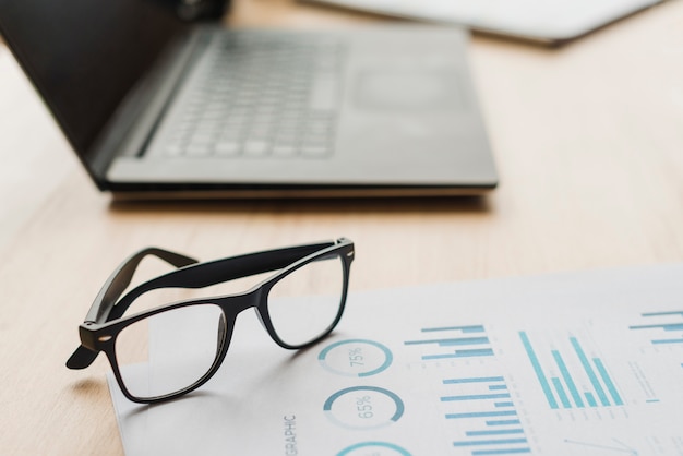 Free photo office desktop with laptop and a glasses