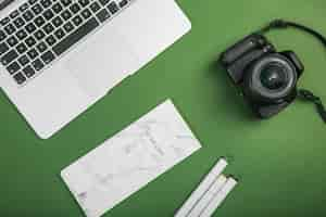 Free photo office desktop with a laptop and a photo camera