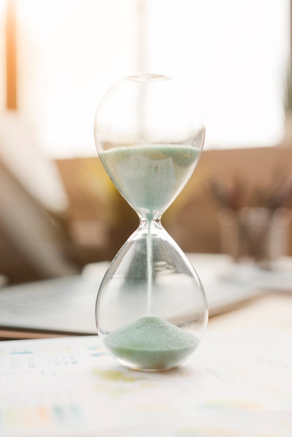 Office desktop with a sand clock