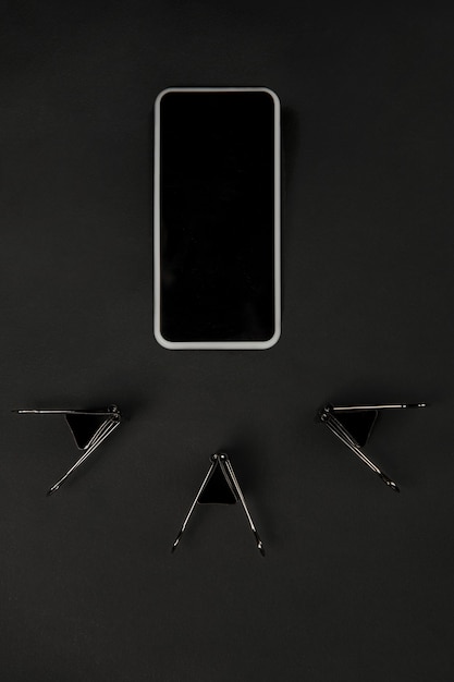 Free Photo office. monochrome stylish and trendy composition in black color surface. top view, flat lay. pure beauty of usual things around. copyspace for ad. close up. smartphone's blank screen.