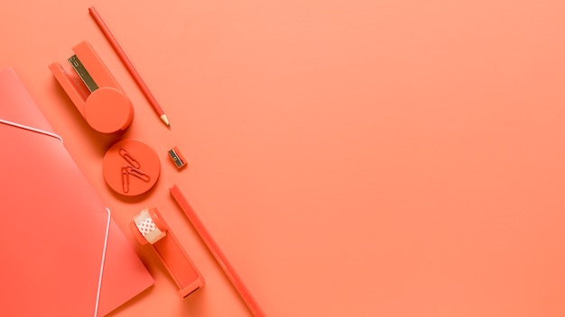 Office supplies on orange background