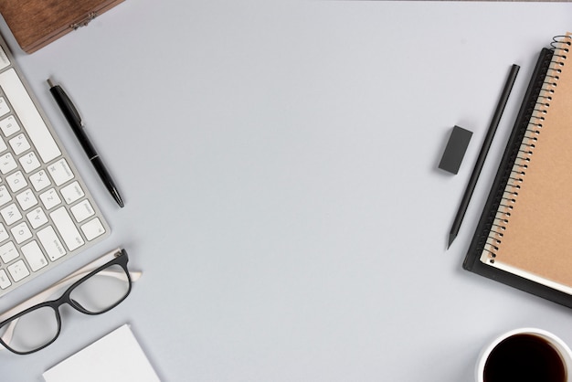 Free photo office supplies with keyboard on gray desk