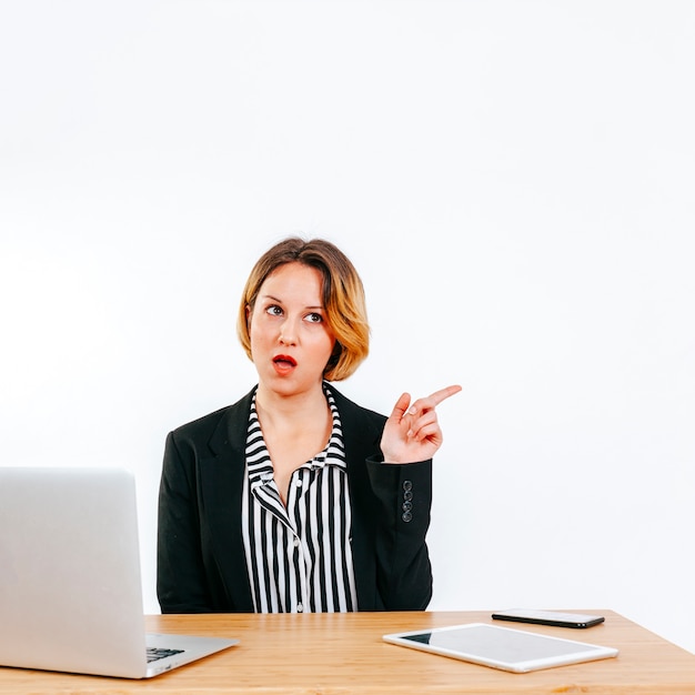 Office worker pointing away on white