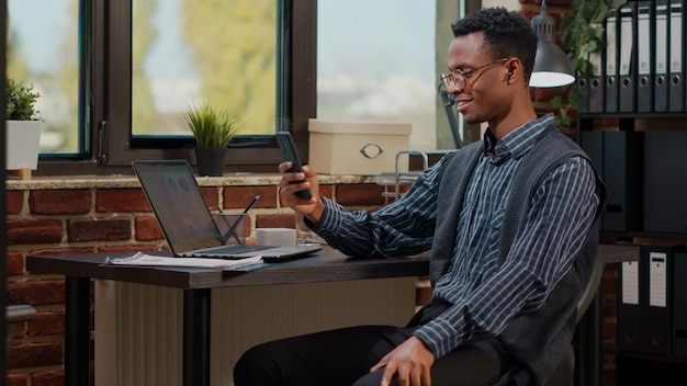 Office worker using smartphone to talk on video call at job, meeting on online videoconference with colleagues. Consultant chatting on remote telework call, using mobile phone.