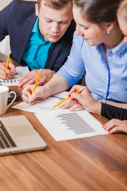 Office workers sitting at desk writing