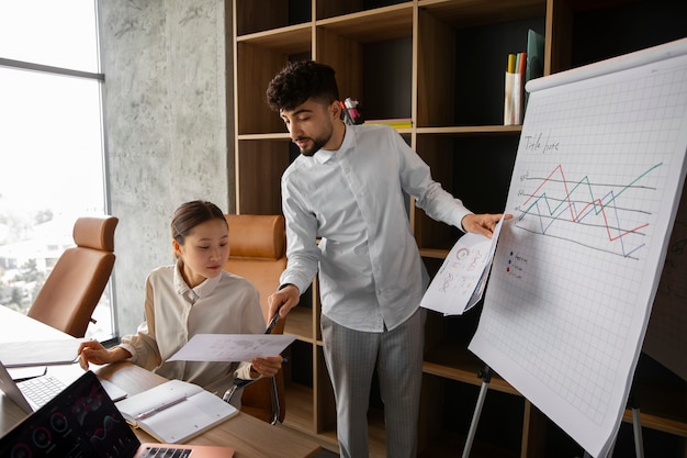 Free Photo office workers using finance graphs